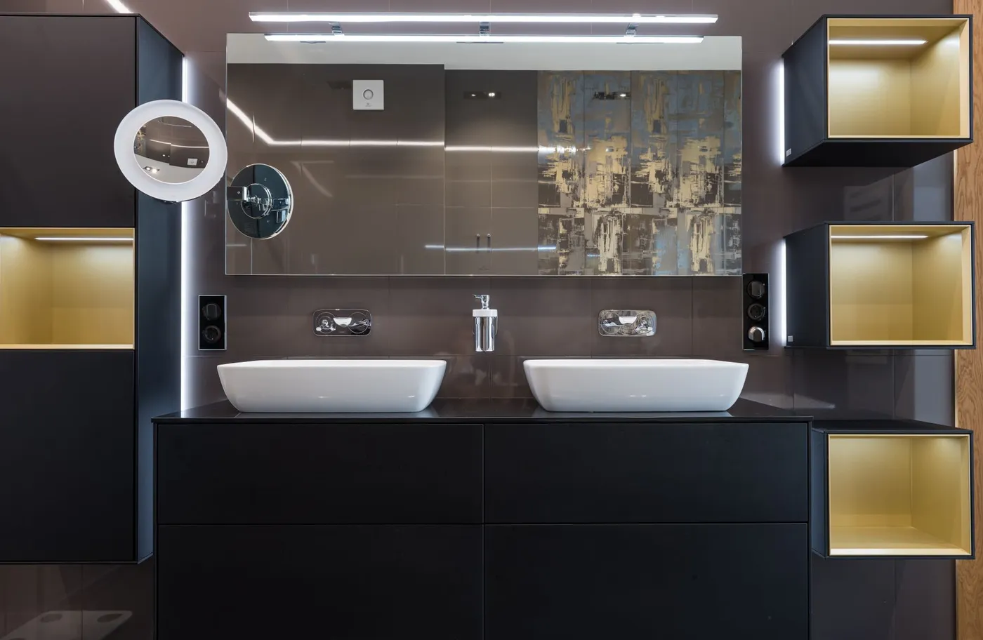 Restroom vanity with twin basins, backlit mirror and warm shelf lighting