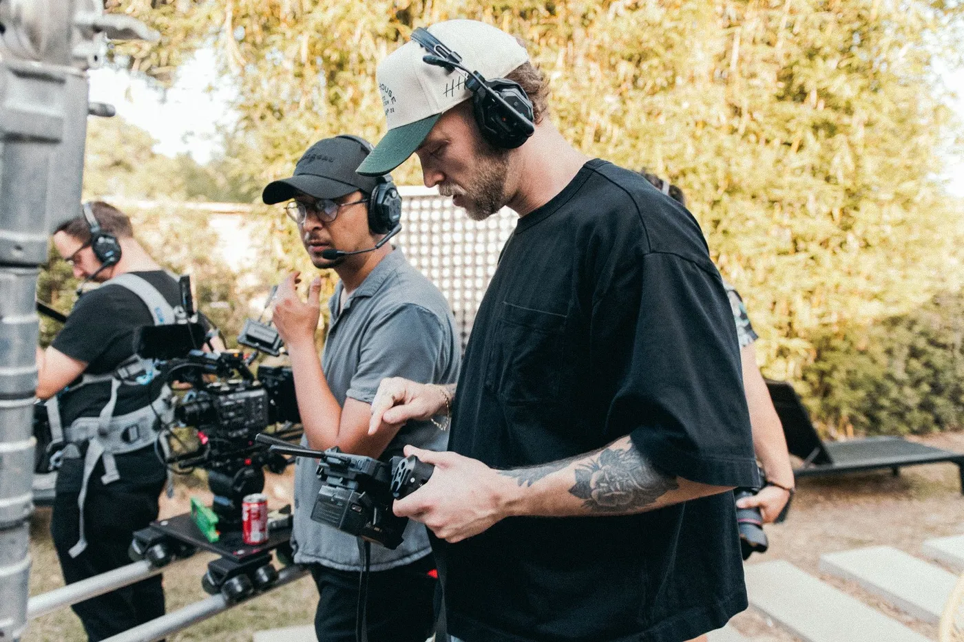 Film crew setting up equipment outdoors