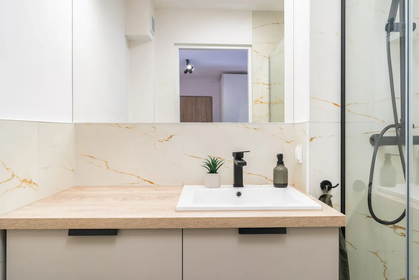 Bright, clean restroom vanity and mirror